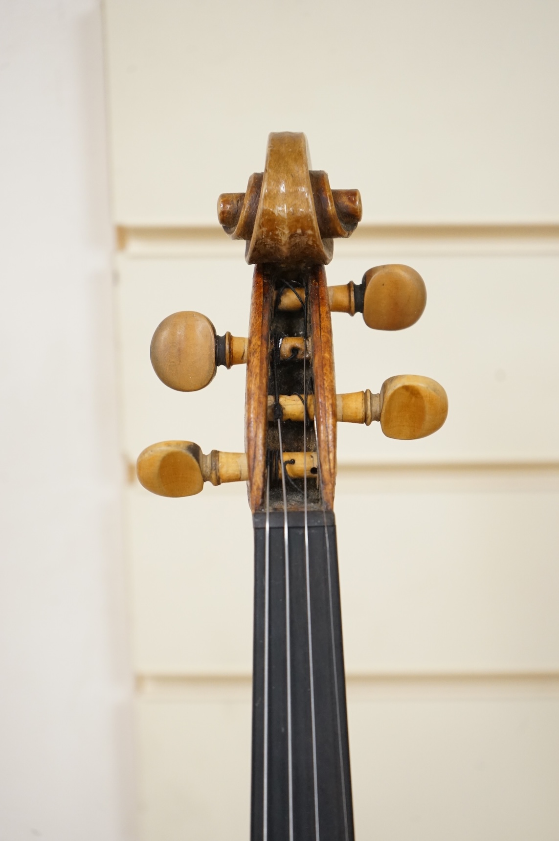 Five cased 20th century violins, including; a German violin, two Czech violins, a three-quarter size violin with a label for Bienfait, and a Romanian quarter size violin, all in cases or the remains of cases.
